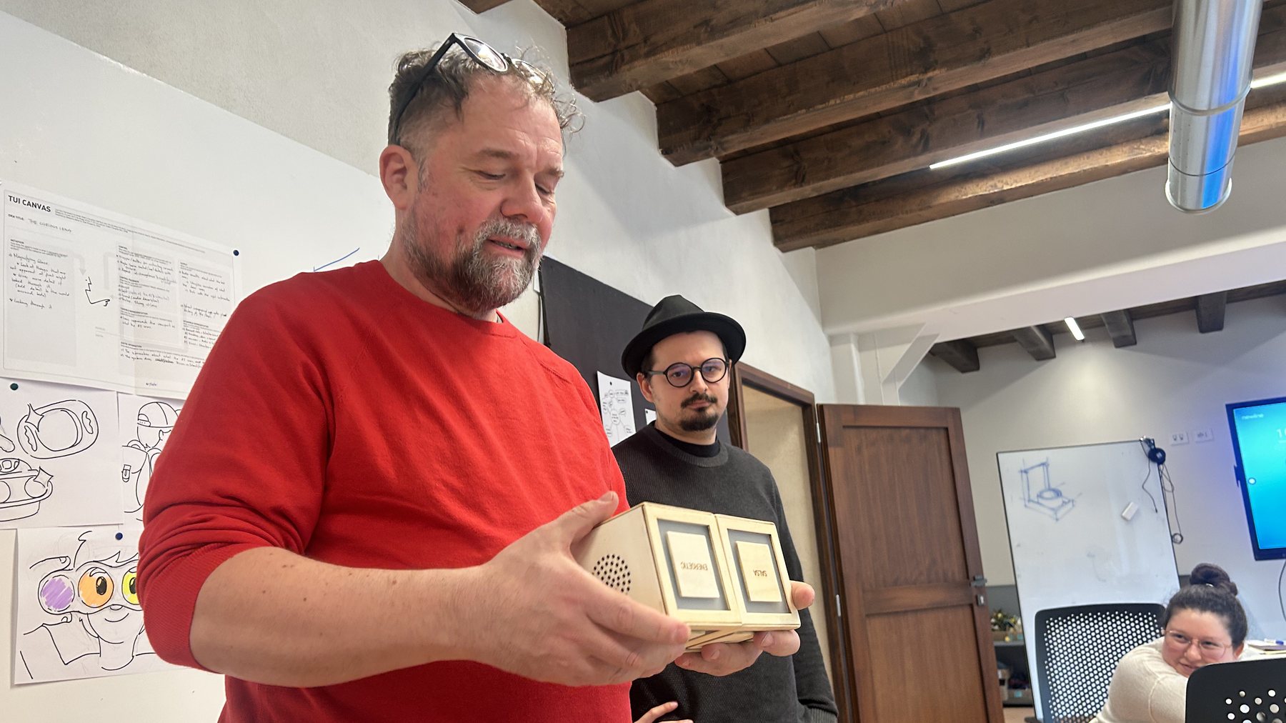 Presenting Cubit: a teacher holds the two cubes during the final demo