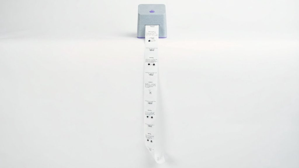 The HELD device printing a long strip of notes